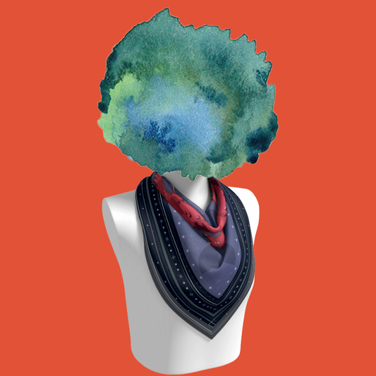 Dragon Egg Adventure silk scarf tied on mannequin bust on orange background by Leeloo + Zohan