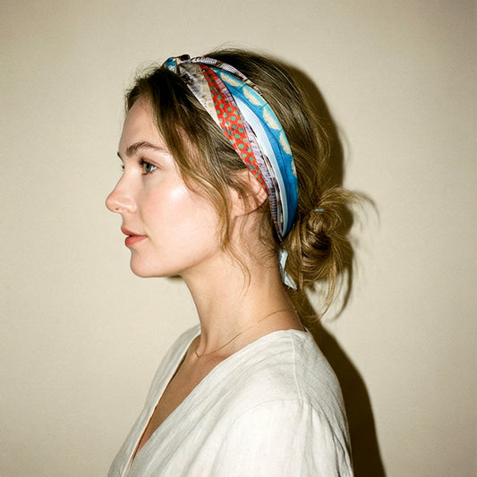 Model wearing American Graffiti silk scarf as headband in profile view by Leeloo + Zohan — Square Scarf