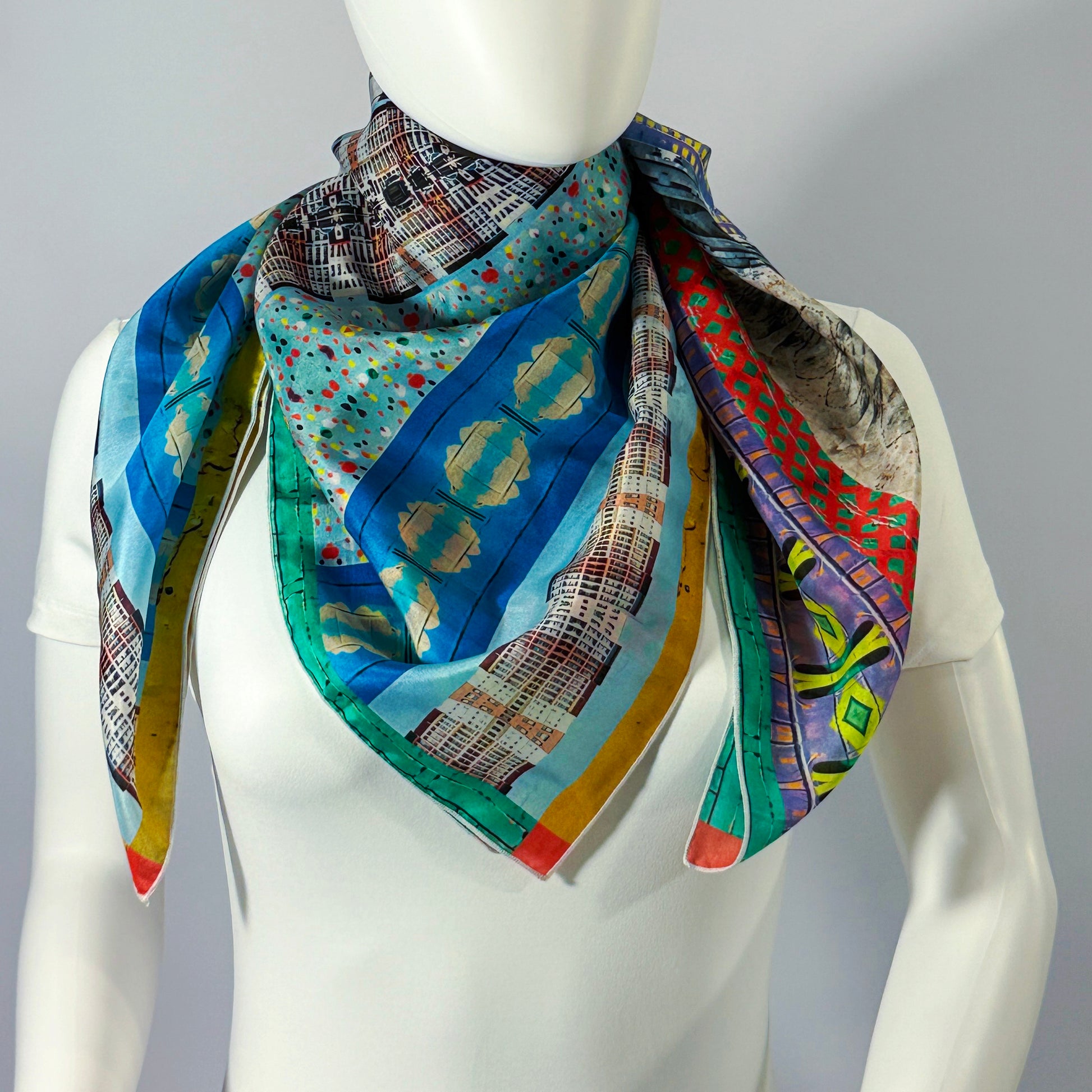 American Graffiti silk scarf tied at the neck on a form — vertical bands of colorful street-art pattern.—Square Scarf