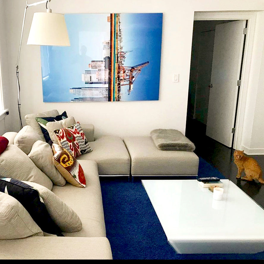 Photographic collage of the Manhattan skyline and harbor cranes by Paul Morris, installed in a New York living room