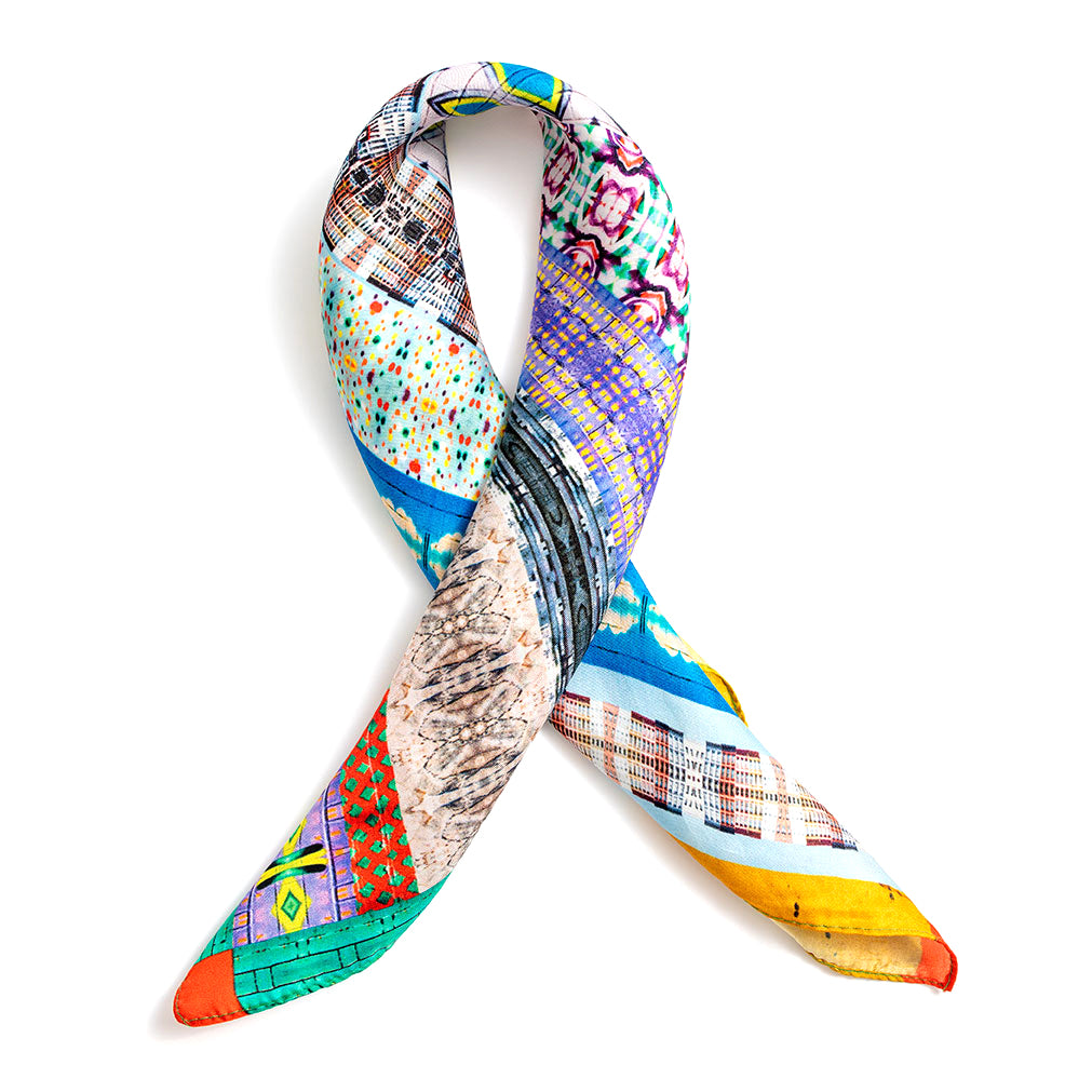 American Graffiti silk scarf twisted into ribbon shape on white background by Leeloo + Zohan