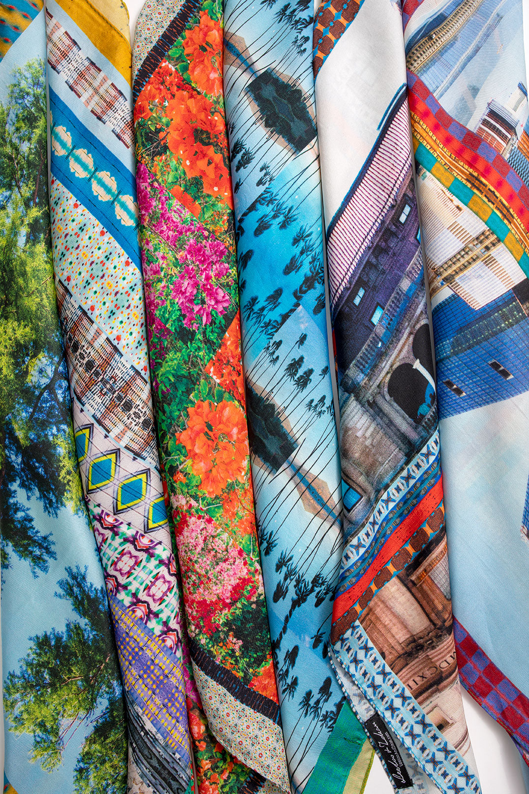 Multiple Leeloo + Zohan silk scarves including American Graffiti rolled and stacked together