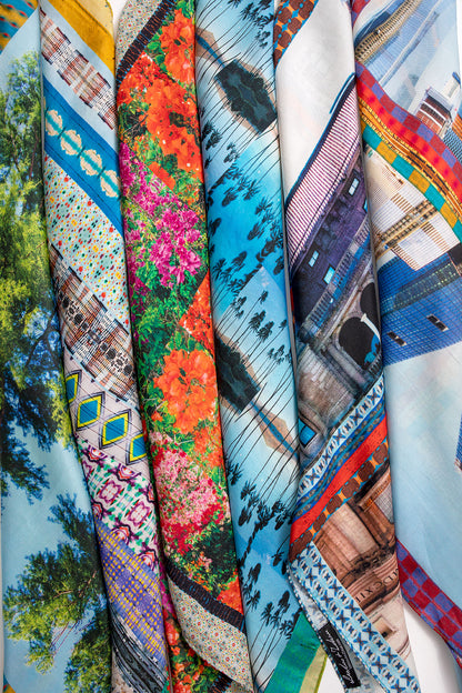 Multiple Leeloo + Zohan silk scarves including American Graffiti rolled and stacked together