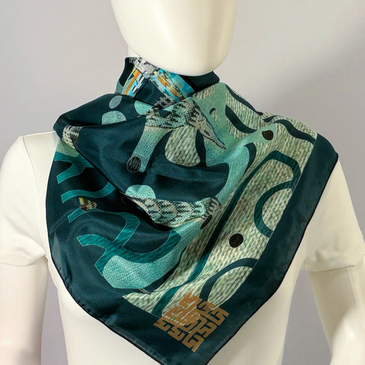 Egyptian P. Chrysler silk scarf tied at the neck — shown on form.—Square Scarf