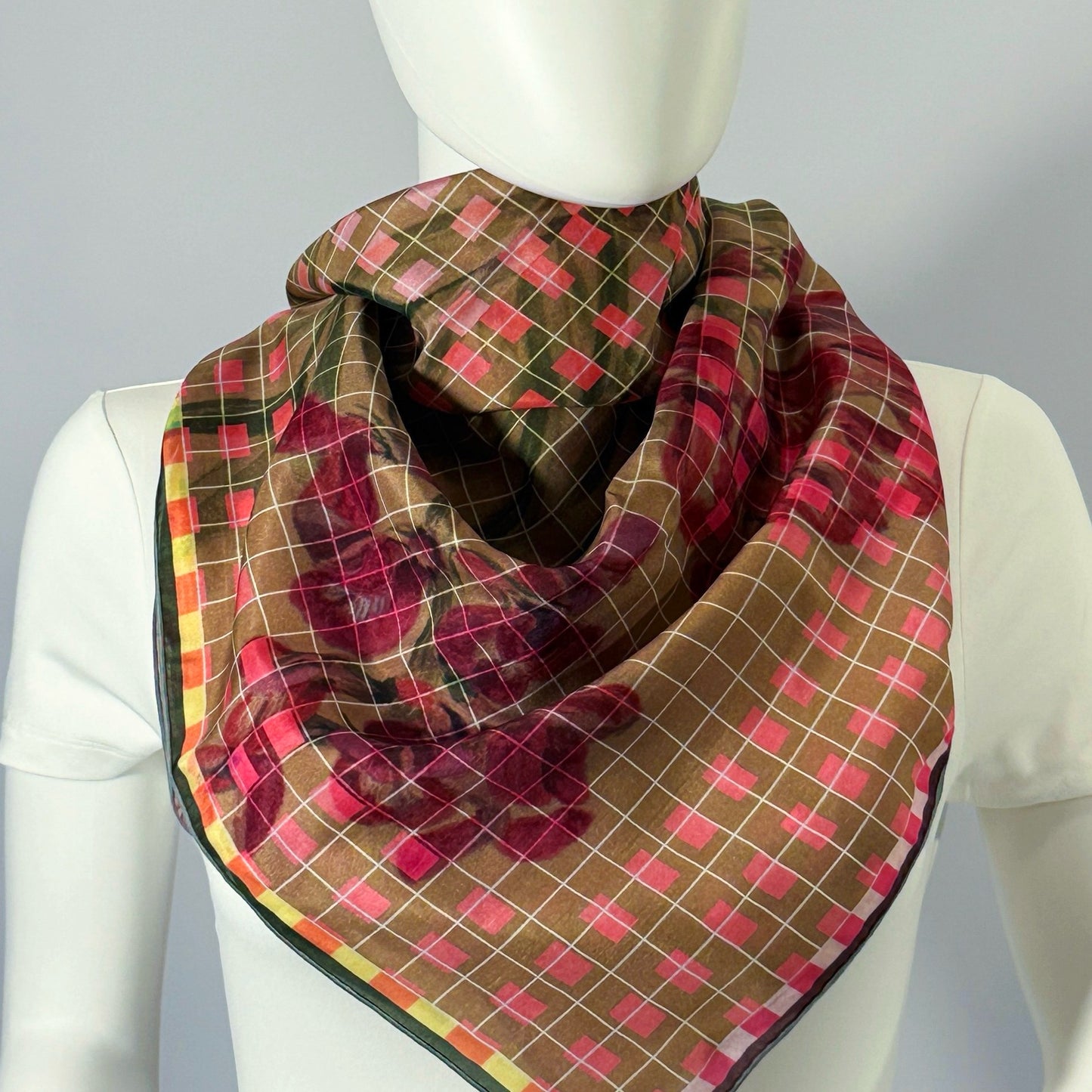 Flowers from The Mesa silk scarf tied at the neck — shown on form.